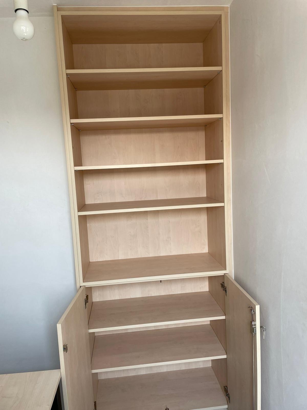 Boekenkast met geopende onderdeuren